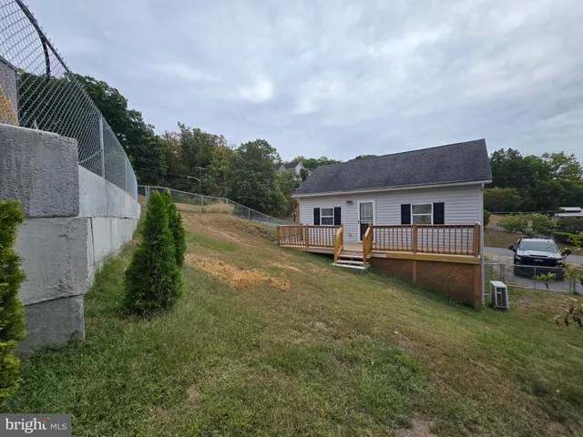 a front view of a house with a garden and yard