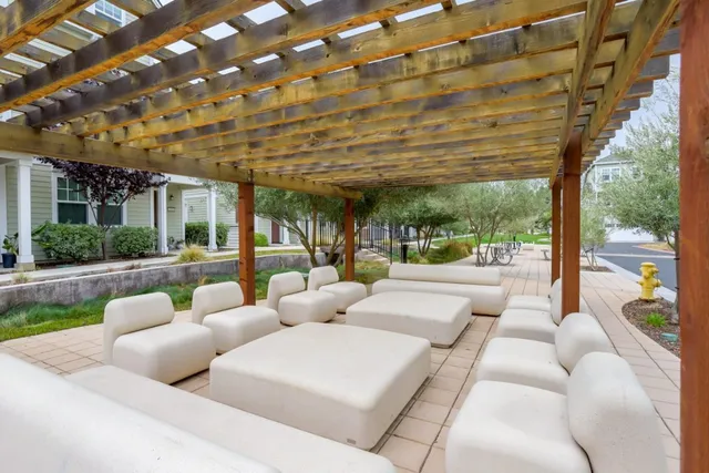 a living room with patio furniture and garden view