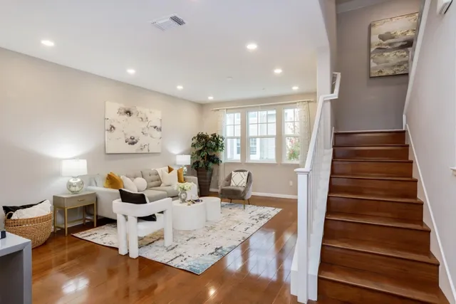 a living room with furniture and wooden floor
