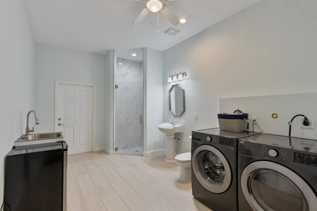a view of a bathroom with sink washer and dryer