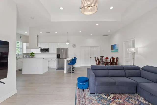 a living room with furniture and kitchen view