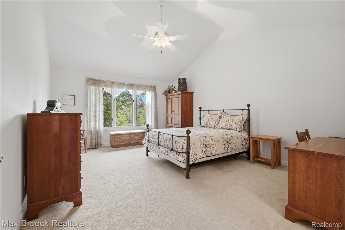 1731 Rico Road Commerce Township, MI 48382 - Photo 21 of 48 Vaulted ceiling with a ceiling fan, broad window, and light-colored carpeting