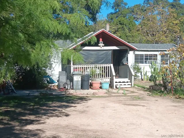 a view of a house with yard and sitting area