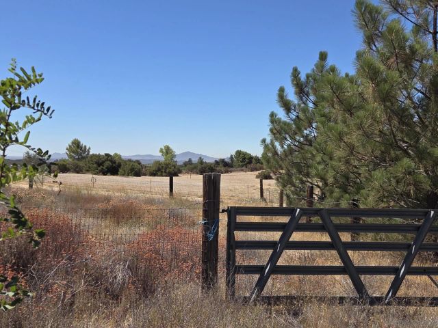 a view of a field with a view of mountains