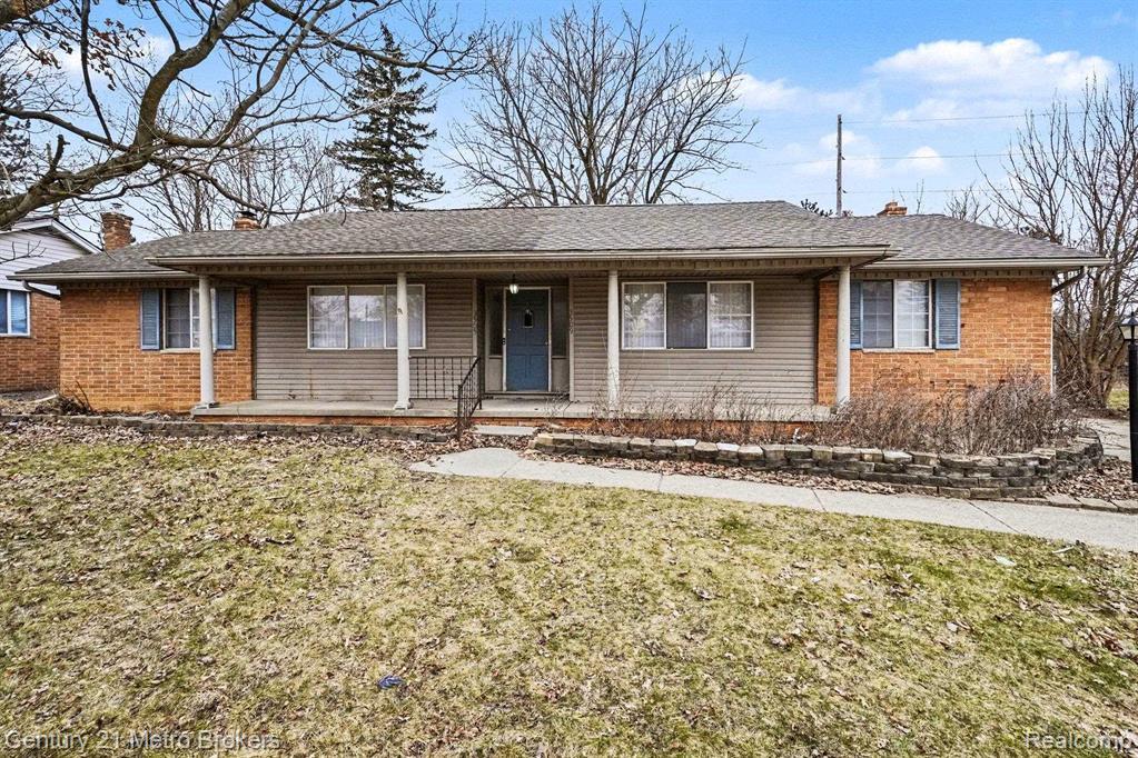 3509 Ridgecliffe Drive Flint, MI 48532 - Photo 1 of 16 Ranch-style residence featuring a covered front porch with white columns, brick facade accents, and a blue entry door