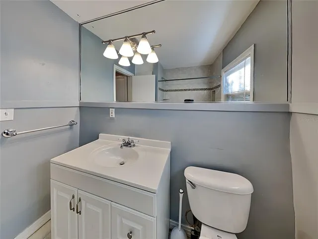 a bathroom with a sink a mirror and a toilet