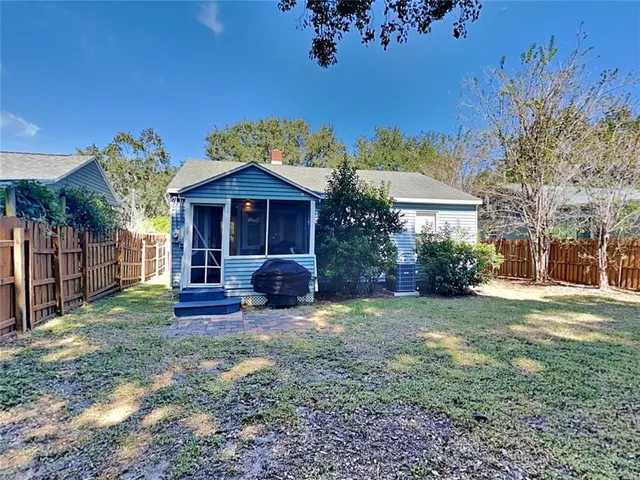 a view of a house with a yard and sitting area