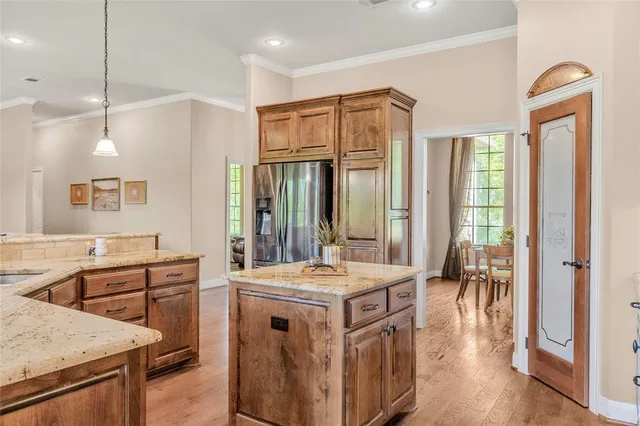 a kitchen that has a stove a sink and a refrigerator