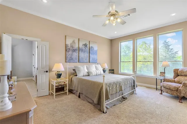 a spacious bedroom with a bed and a chandelier
