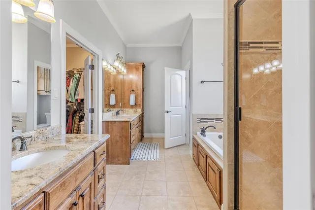 a bathroom with a granite countertop sink a mirror a bathtub and shower