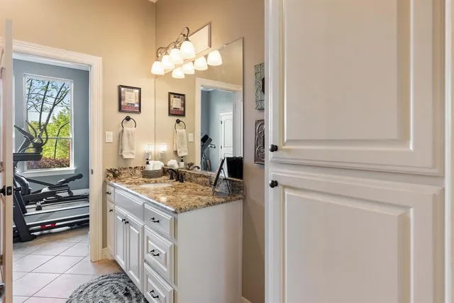 a spacious bedroom with a bed and a chandelier
