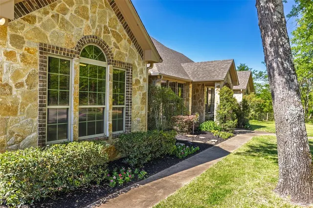 a view of a house with backyard and sitting area