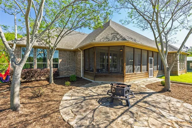 a view of a house with backyard porch and sitting area