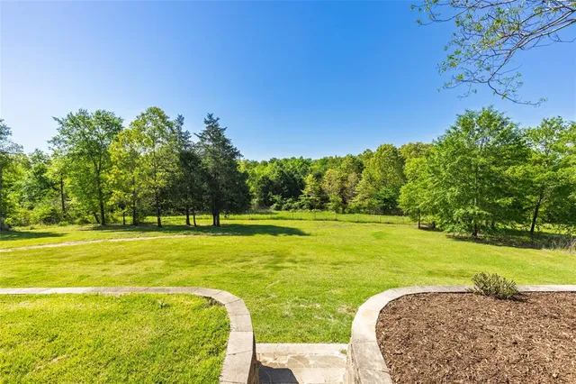 a view of a swimming pool with a yard