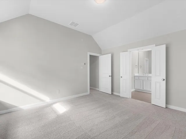 a view of an empty room and closet area