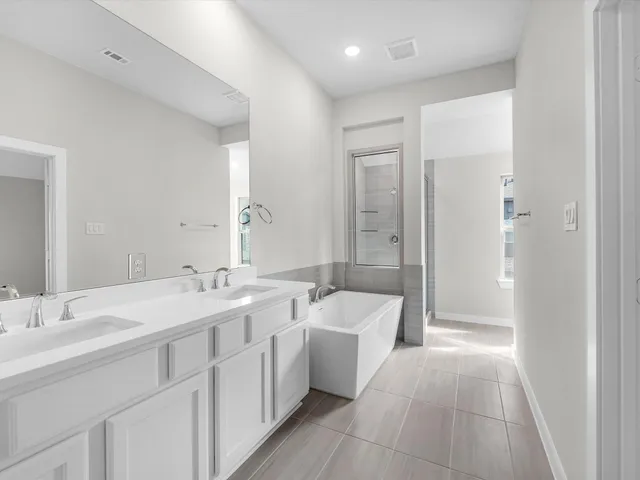 a spacious bathroom with a double vanity sink mirror double and bathtub