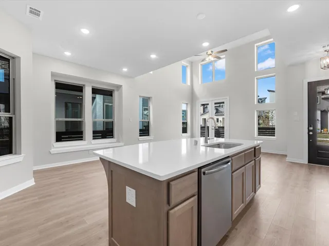 a room with sink and hall with wooden floor