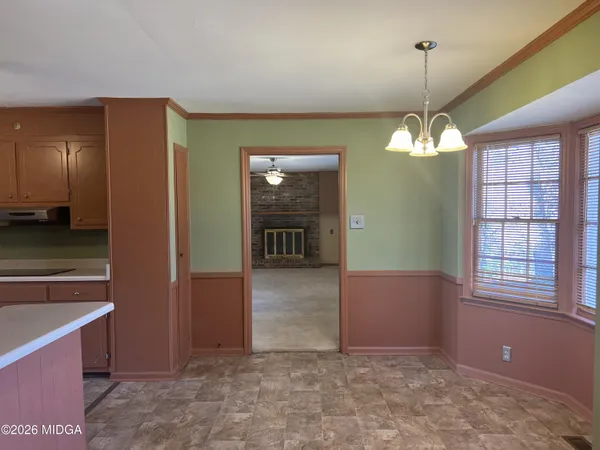 a view of a small space with wooden floor and a window