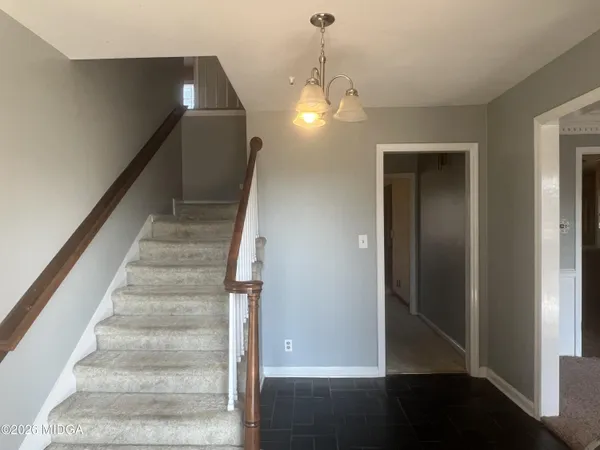 a view of entryway and hall with wooden floor