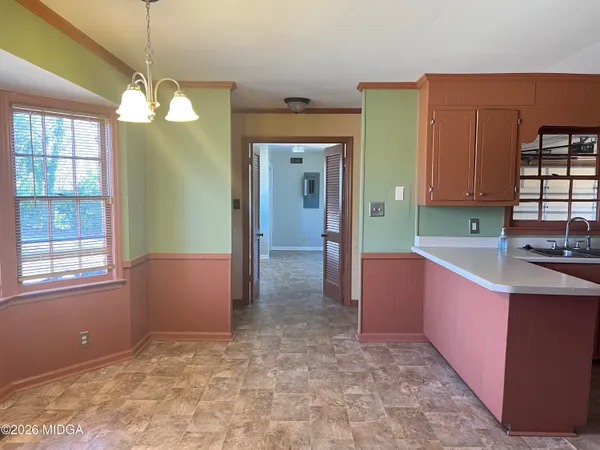 a kitchen with stainless steel appliances granite countertop a sink and cabinets