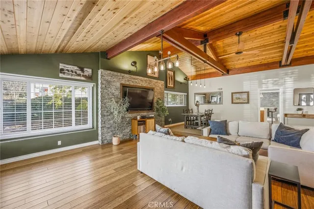 a living room with furniture a fireplace and a table