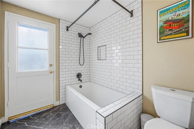 a bathroom with a shower and a glass door