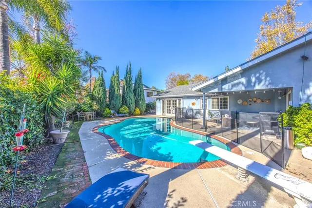 a view of a house with a yard and sitting area
