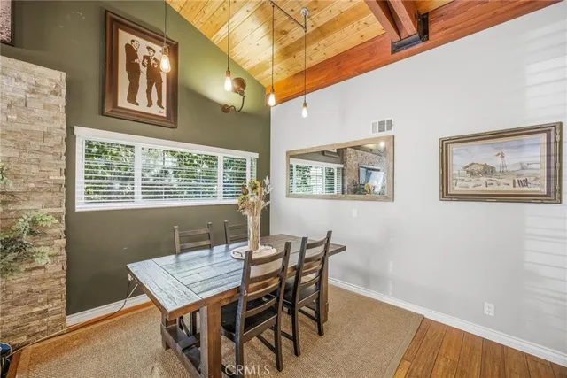 a dining room with furniture and wooden floor