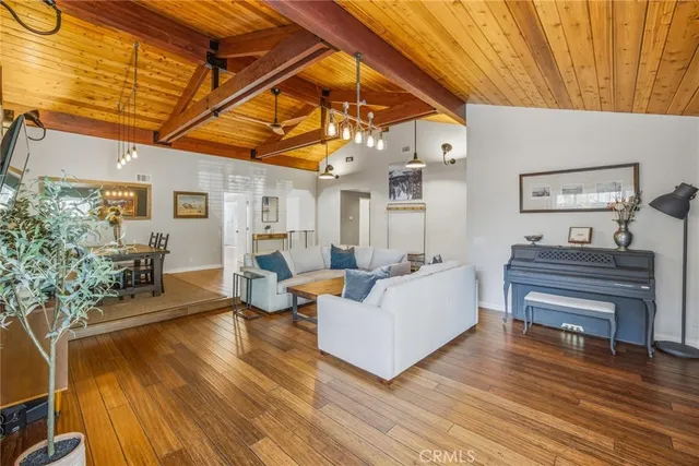 a view of a patio with couches chairs and wooden floor
