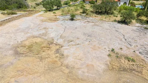 a view of a swimming pool with a yard
