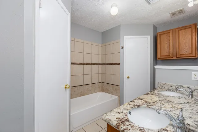 a bathroom with a bathtub and shower