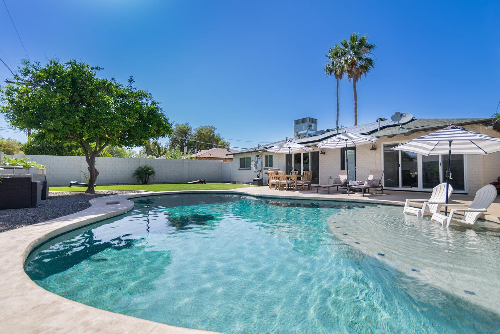 swimming pool view with a seating space