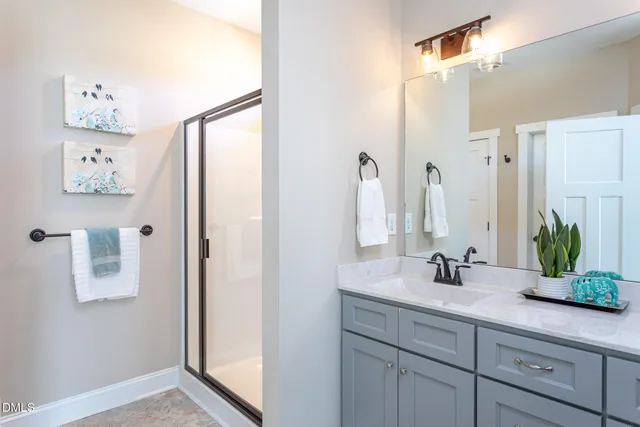 a bathroom with a double vanity sink and a mirror