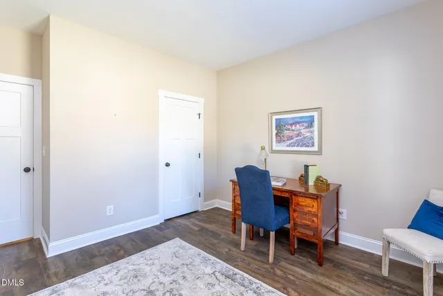 a workspace room with furniture and wooden floor