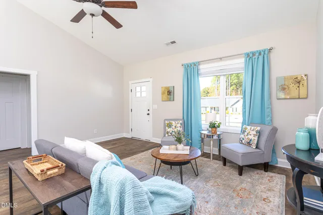 a living room with furniture and wooden floor