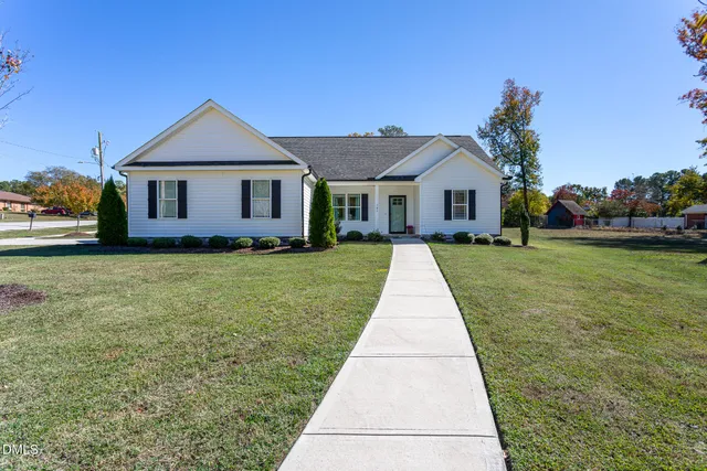 a front view of a house with yard