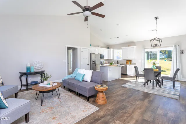 a living room with lots of furniture and kitchen view