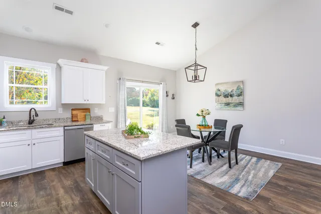 a kitchen with sink cabinets and dining table