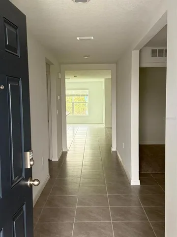 a view of hallway with a window and a mirror