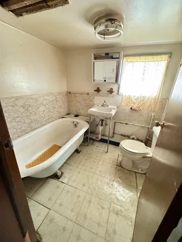 a bathroom with a sink a toilet and a bathtub