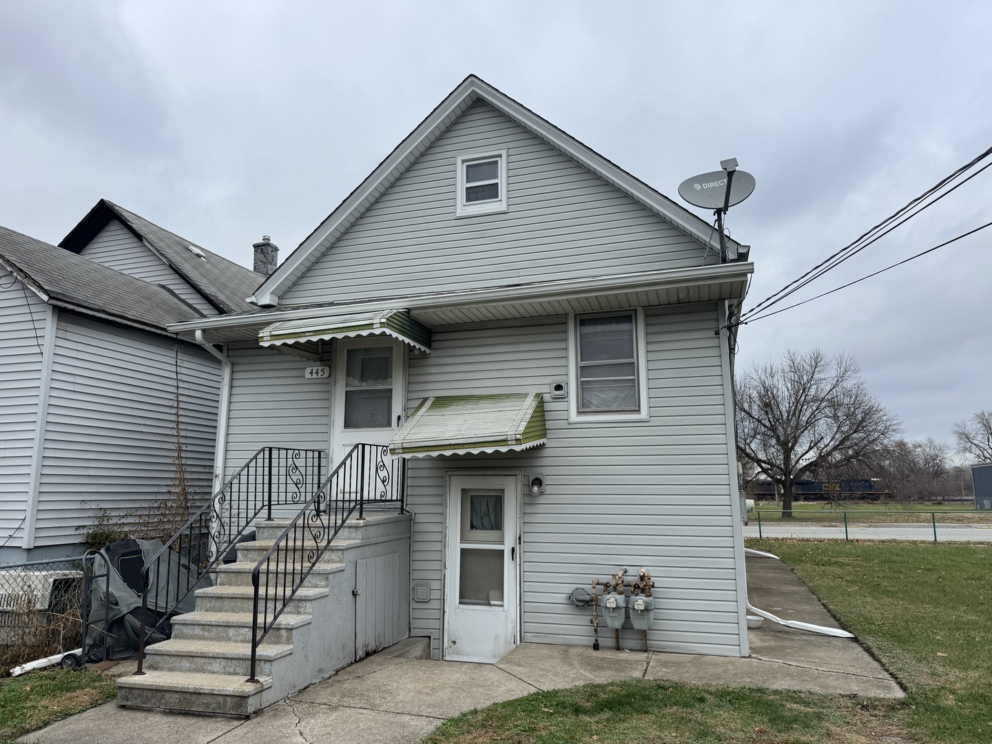 445 State Street Calumet City, IL 60409 - Photo 4 of 15 a front view of a house with garage