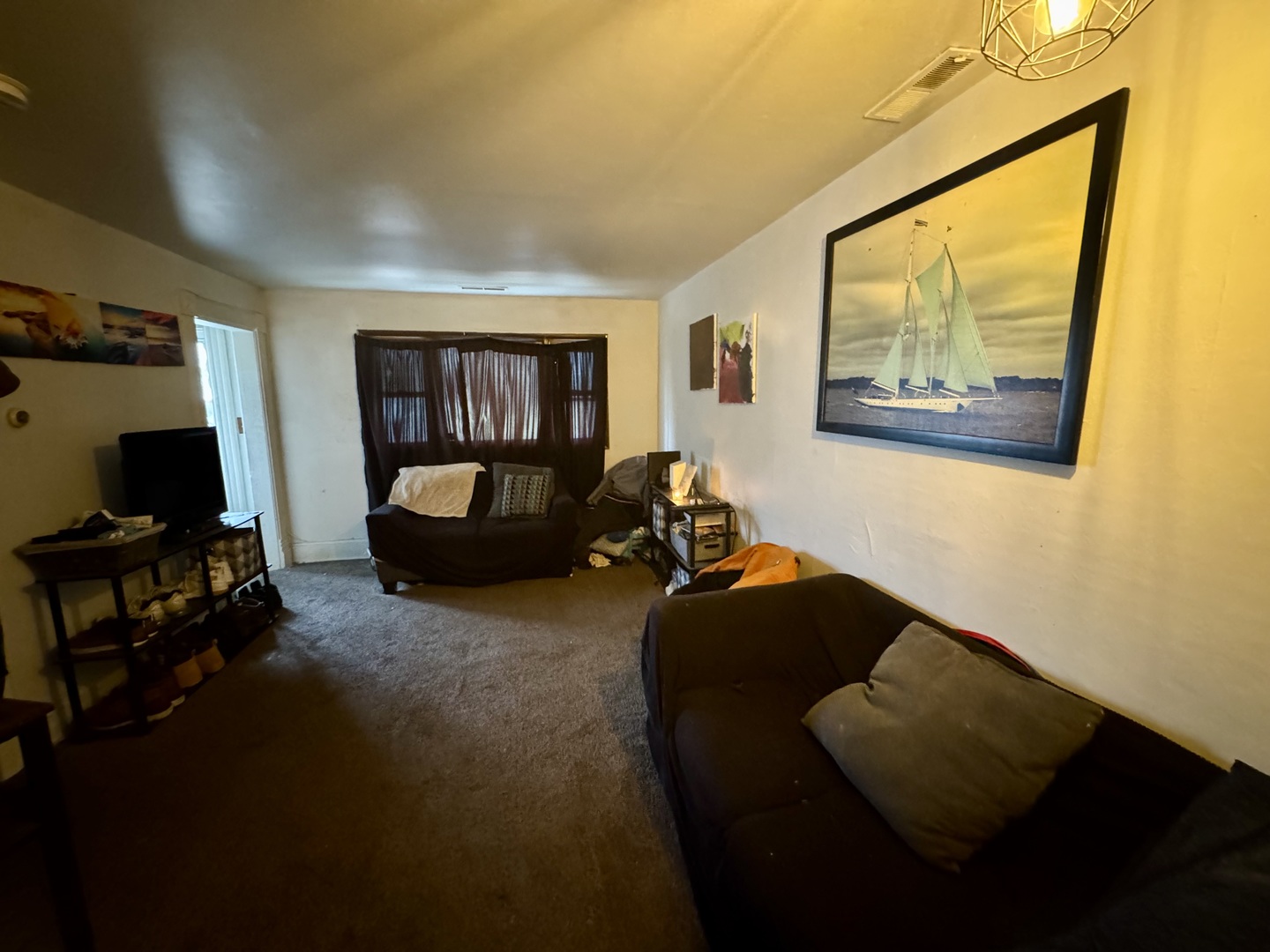 445 State Street Calumet City, IL 60409 - Photo 5 of 15 a living room with furniture and a flat screen tv