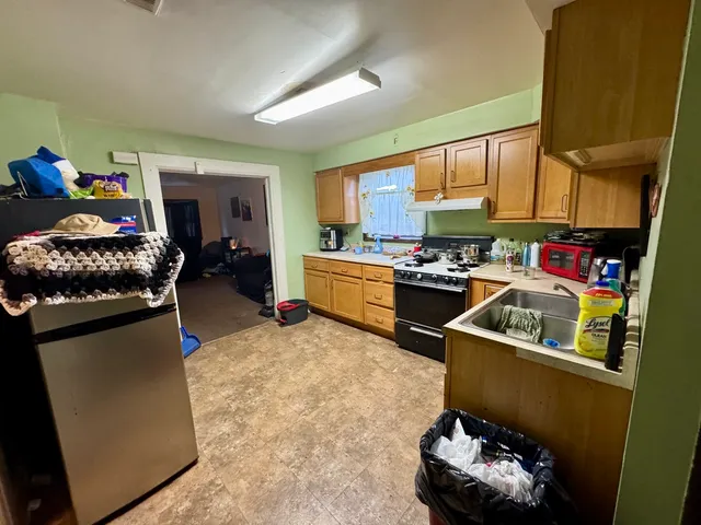 a kitchen with a sink appliances and cabinets