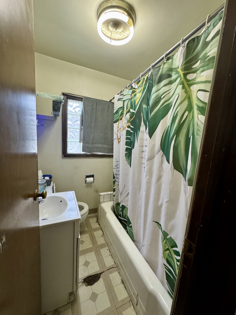 445 State Street Calumet City, IL 60409 - Photo 8 of 15 a bathroom with a sink and mirror