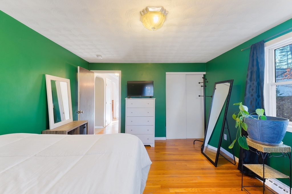 3 Riverside Road Billerica, MA 01821 - Photo 13 of 42 a bedroom with a bed and a potted plant