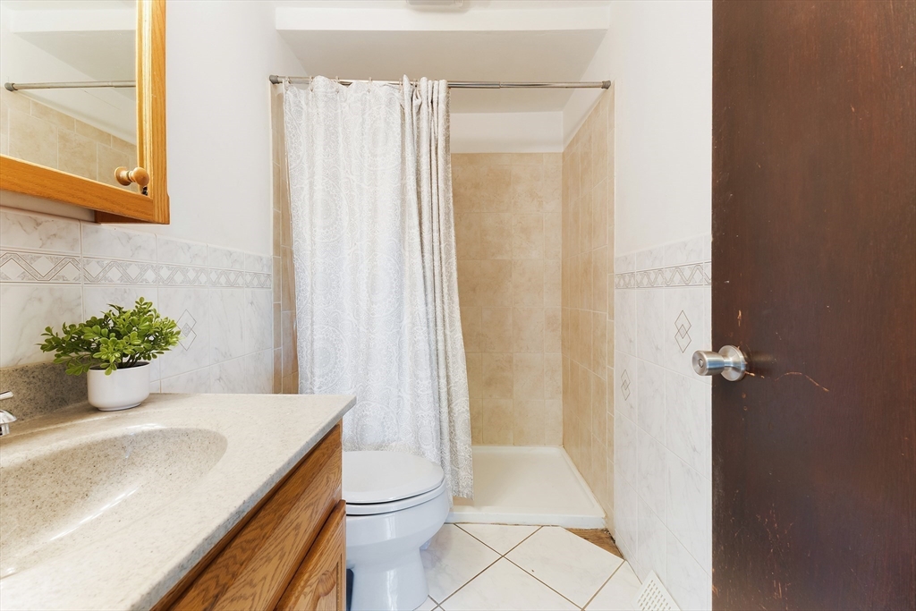 3 Riverside Road Billerica, MA 01821 - Photo 15 of 42 a bathroom with a sink and a mirror