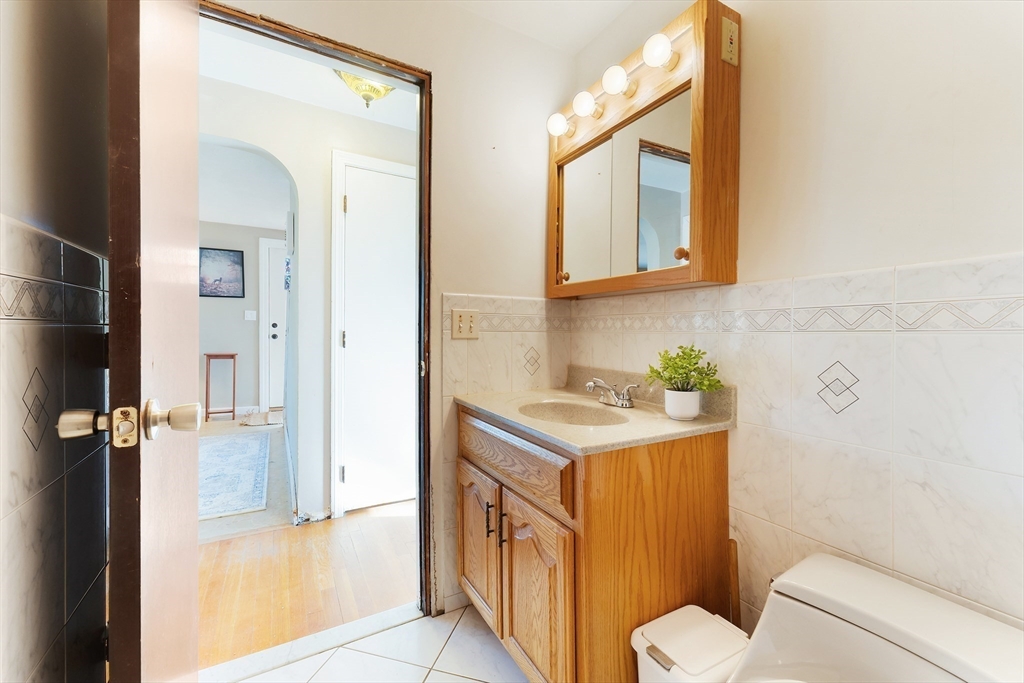 3 Riverside Road Billerica, MA 01821 - Photo 16 of 42 a bathroom with a sink a toilet and a mirror