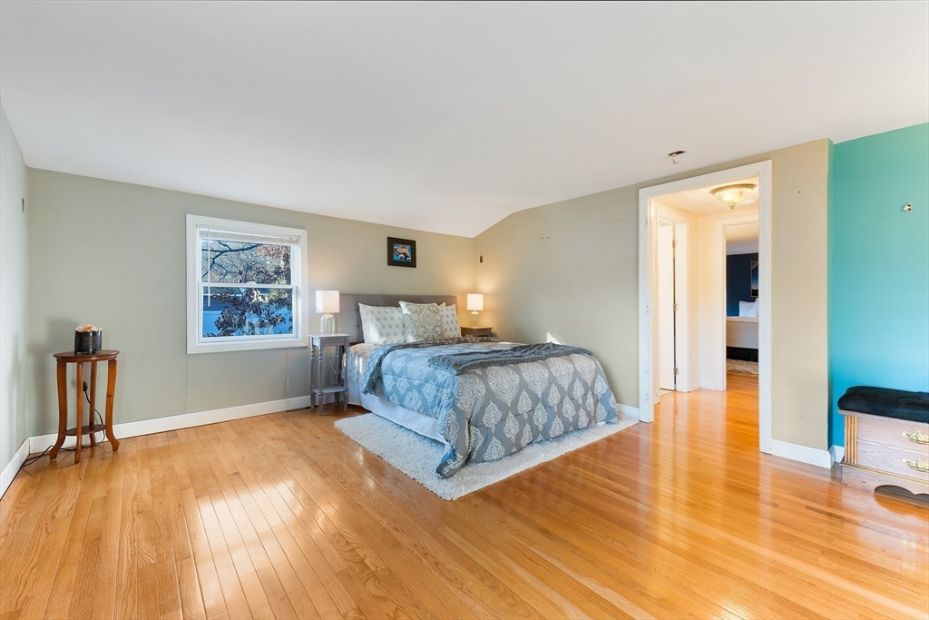 3 Riverside Road Billerica, MA 01821 - Photo 23 of 42 a bedroom with a bed and wooden floor