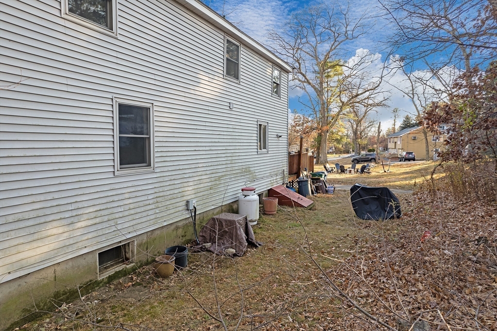 3 Riverside Road Billerica, MA 01821 - Photo 33 of 42 a view of a chairs and table in the back yard of the house