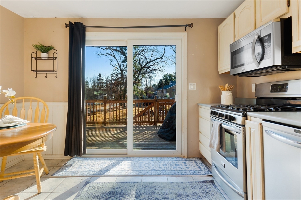3 Riverside Road Billerica, MA 01821 - Photo 6 of 42 a kitchen with stainless steel appliances granite countertop a refrigerator a stove top oven and a sink with granite countertops